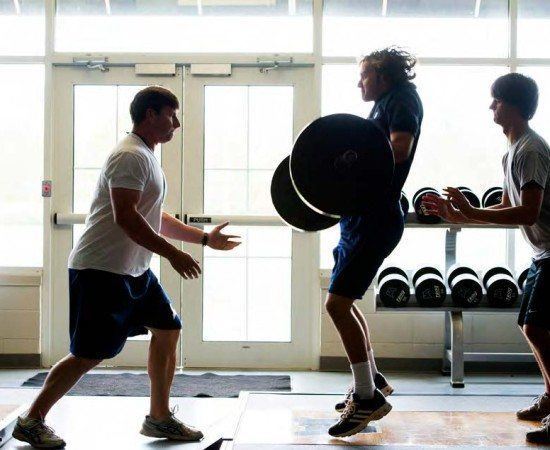 Students work out in the weight room